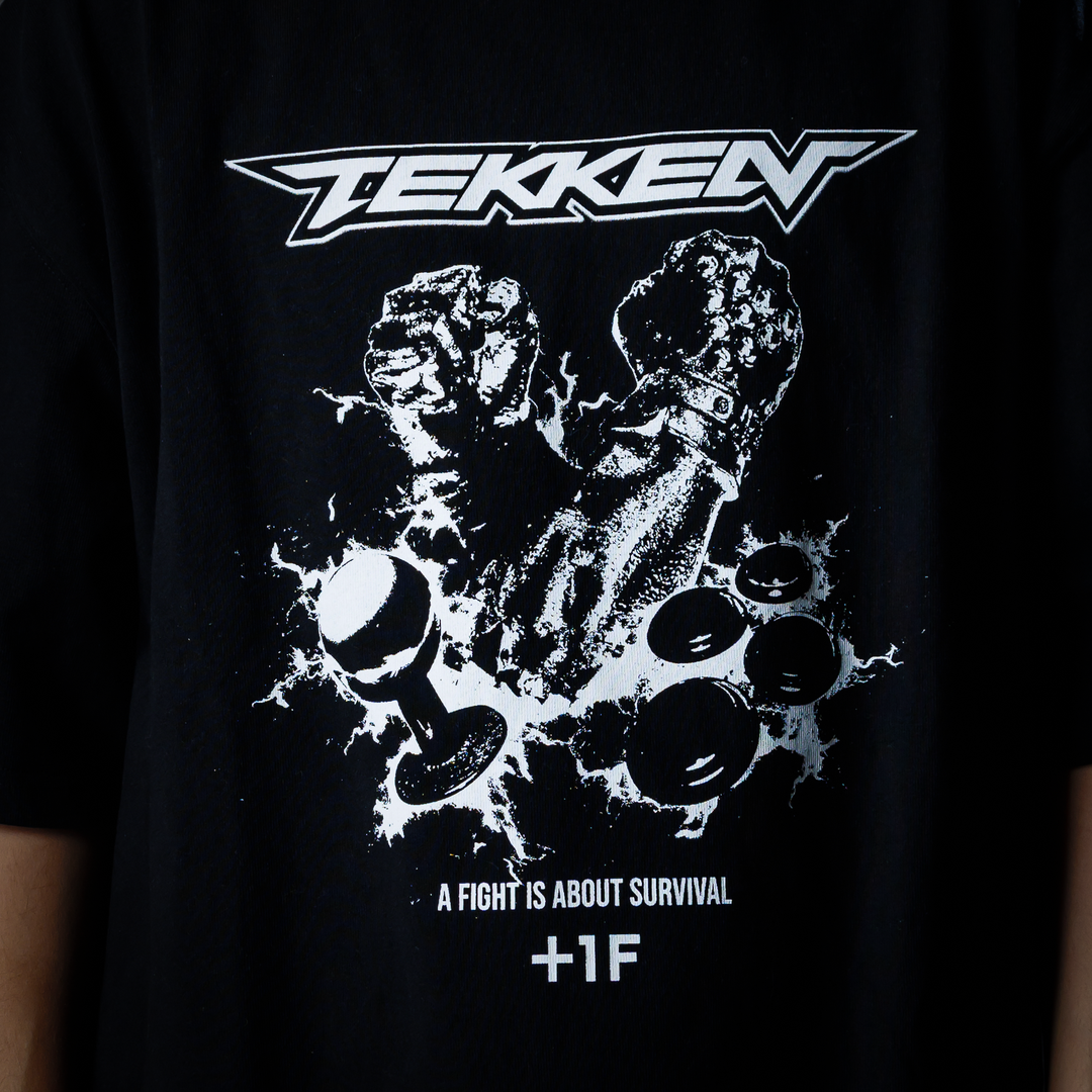 TEKKEN +1F FIGHT IS ABOUT SURVIVAL TEE | 鉄拳 Tシャツ ブラック 黒 TEKKEN +1F FIGHT IS ABOUT SURVIVAL TEE | 鉄拳 Tシャツ ブラック 黒
